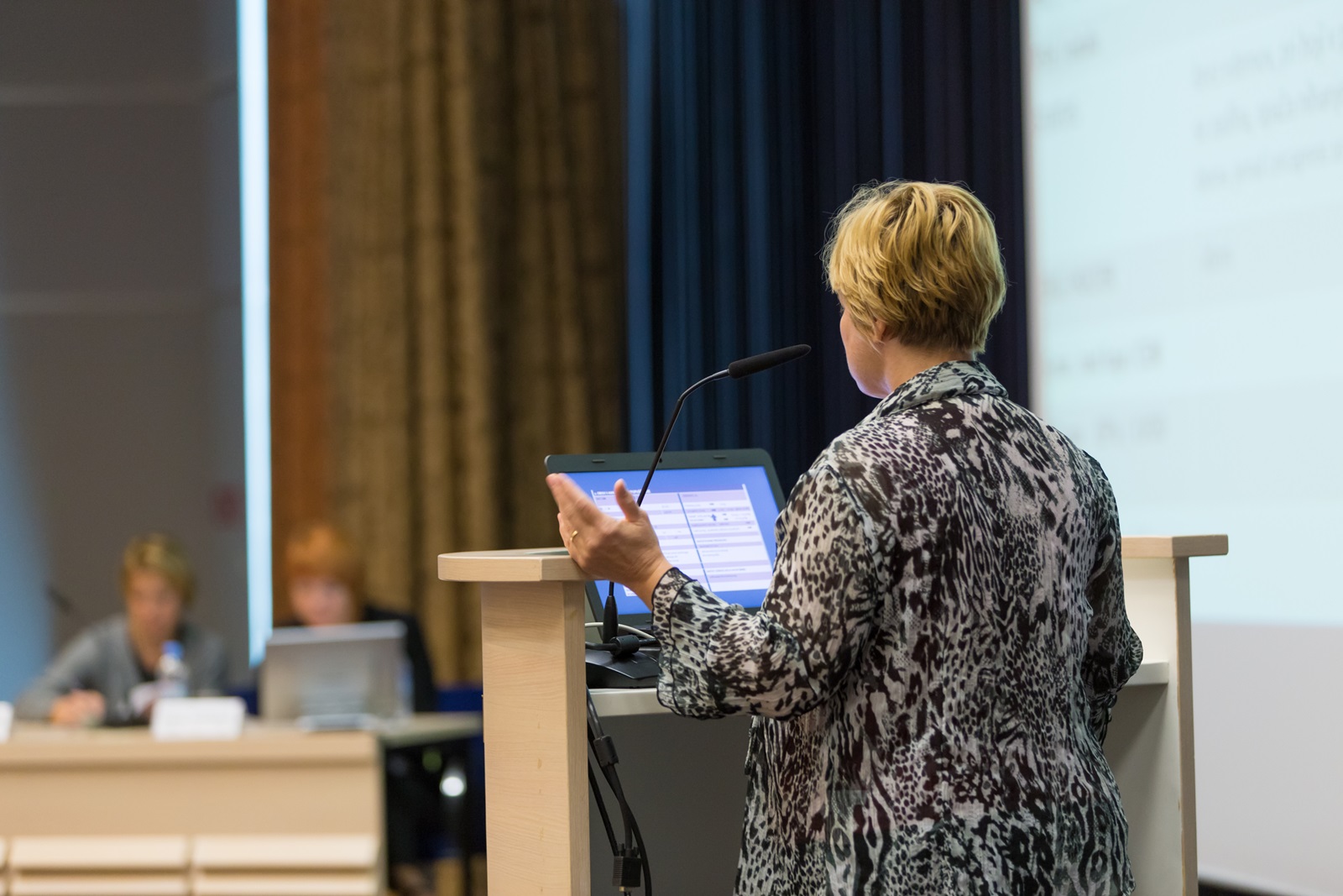 Blond female speaker presents at a scientific conference